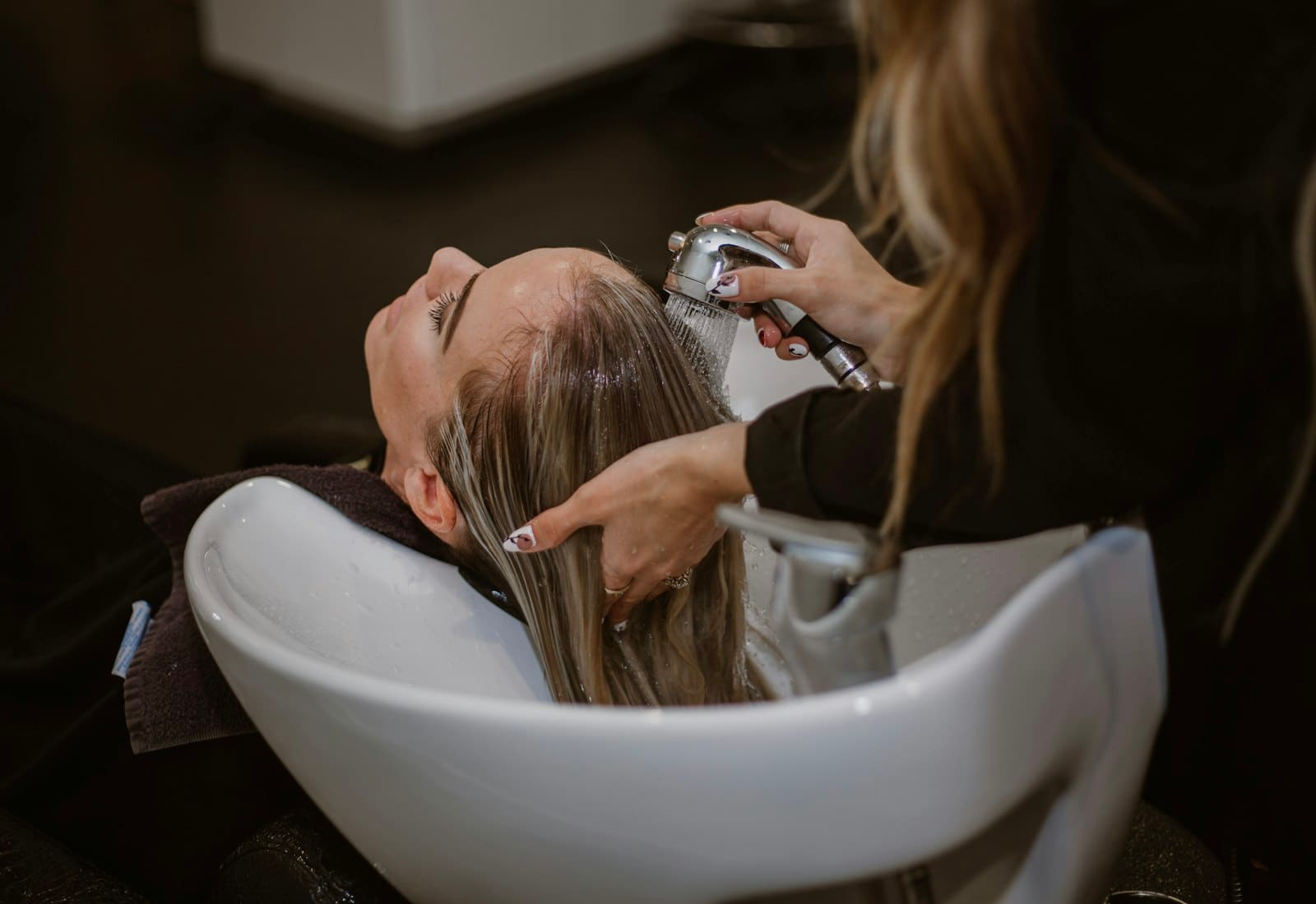 A salon chair beside a well-organised station of brushes and tools
