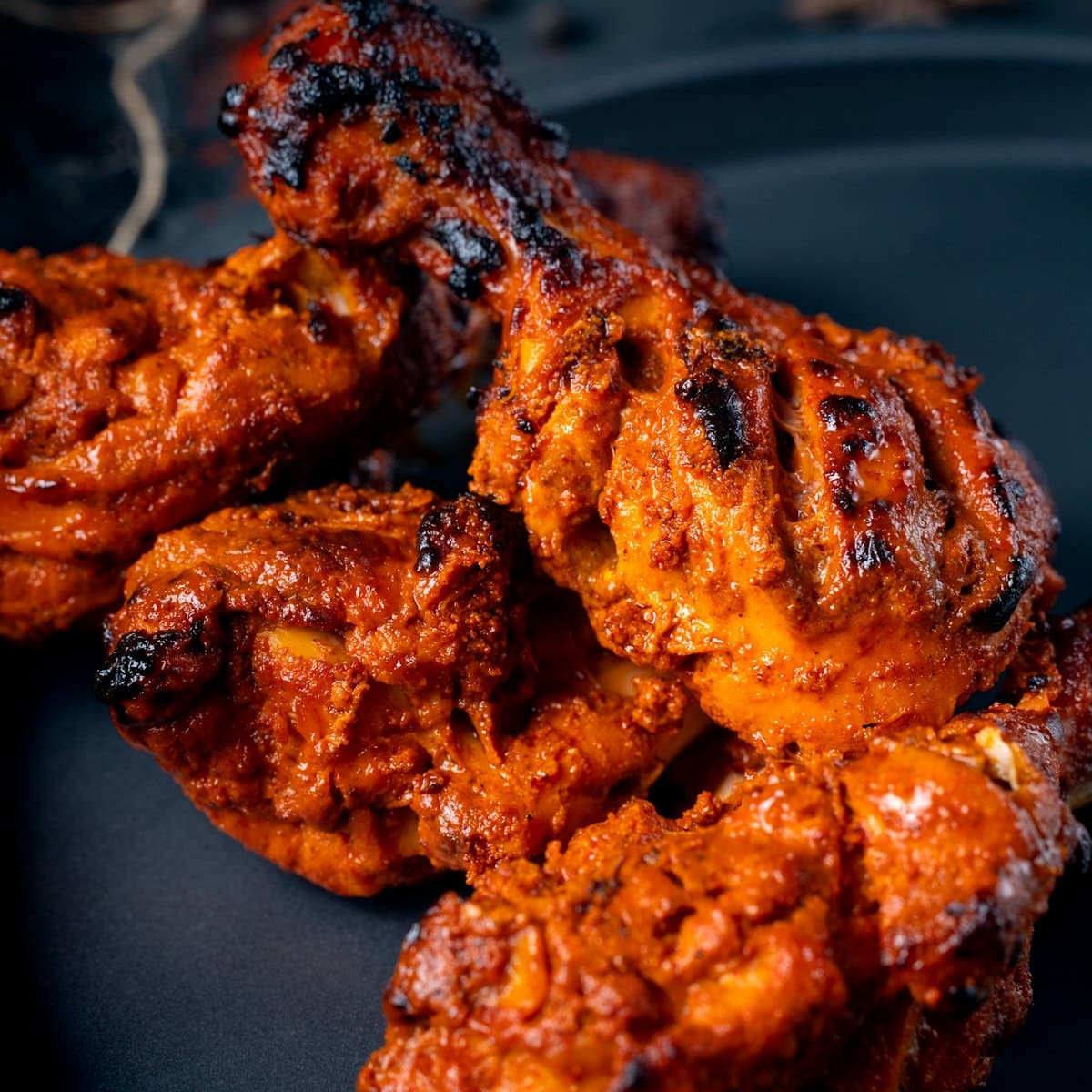 Tandoori chicken close up, charred at the edges